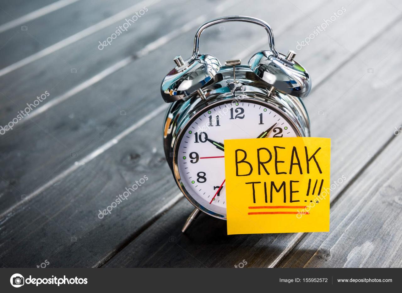 Close up of alarm clock with message break time on wooden tabletop ... Close up of alarm clock with message break time on wooden tabletop ...